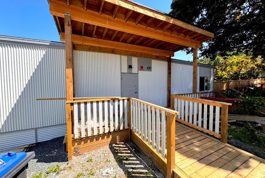 Covered cedar pergola entrance with accessibility ramp