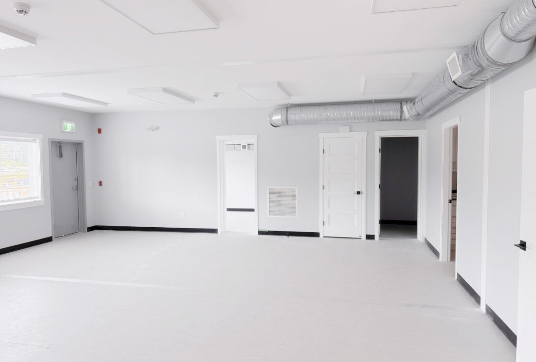 Interior common room with spiral ductwork and LED panels