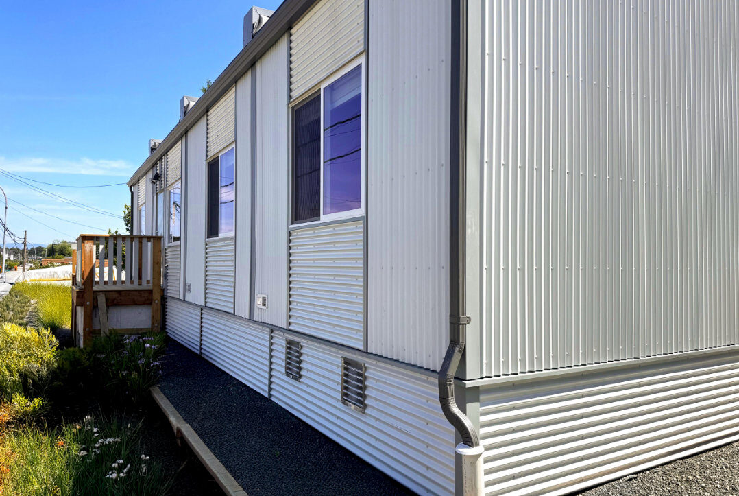Exterior side elevation with wood deck and landscaping